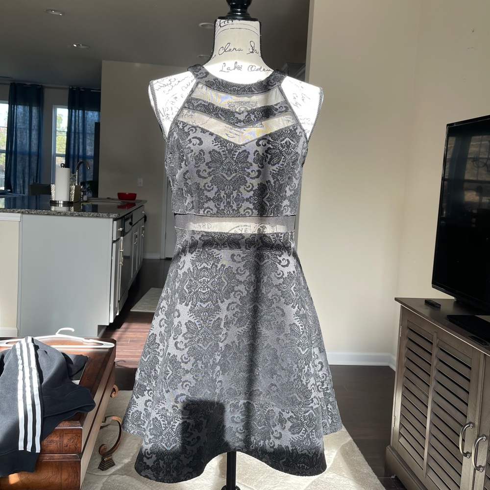 A black partially see-through dress.